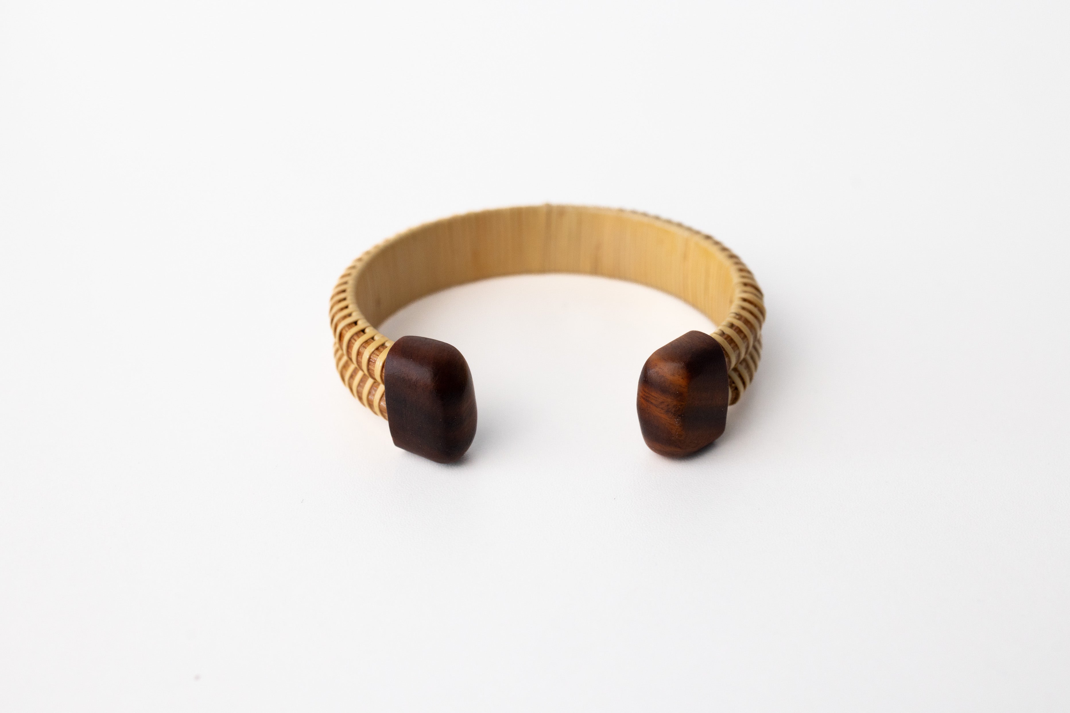 The inside of a double stave Nantucket basket cuff bracelet with cherry hardwood caps.